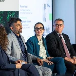 Five people sat in a row looking at each other while one person talks