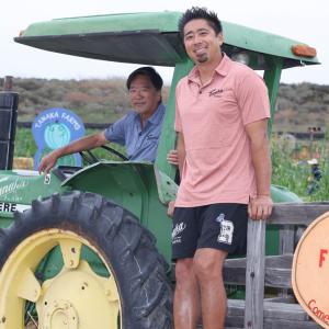Tankaka Farms fall harvest. Kenny Tankaka shown with a tractor.