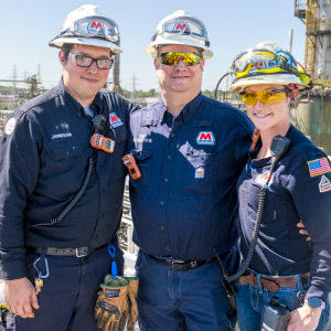 Tara Chippewa (r) with her brother Jamieson Richardson (l) and her father Ray Richardson (center) with the Detroit refinery behind them.