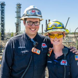 Tara Chippewa with her brother Jamieson Richardson in work and safety gear overlooking the plant in the background.