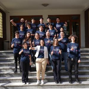Large group of students on school entry steps.