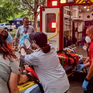 Emergency personnel loading a patient into an ambulance