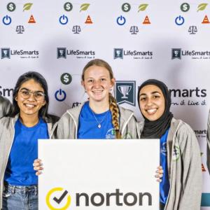 A team of five students holding a Norton sign.