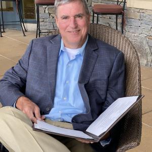 Terry Gwinn holding open binder