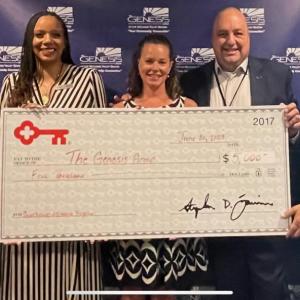 Photo of The Genesis Group receiving a grant check from KeyBank representatives.