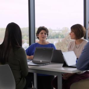 Lynn Penny in a meeting with 3 other people