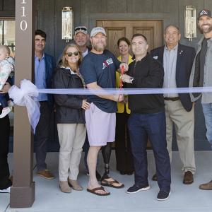 Staff Sergeant Chris Burrell and The Home Depot Foundation volunteers in front of his home.