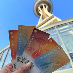 Thelma Gomes holding tickets for the Space Needle.