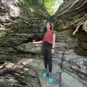 Thelma Gomes posing on the edge of a rocky outcrop.