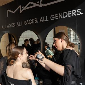 makeup artist working with a model