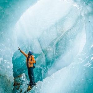Thomas Allison photograph of an ice climber inside a glacier.