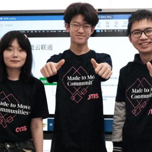 Three students giving a thumbs up.