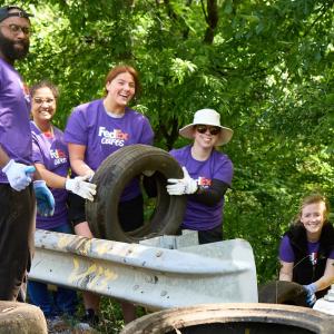 Group of Volunteers holding a tire