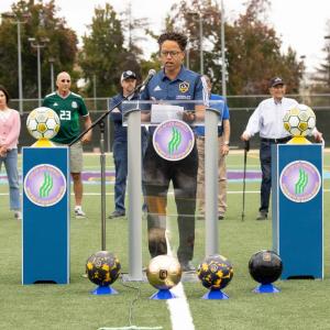 LA Galaxy legend Cobi Jones addresses the crowd from centerfield of "Tommy's Field" at Westwood Park Recreation Center.