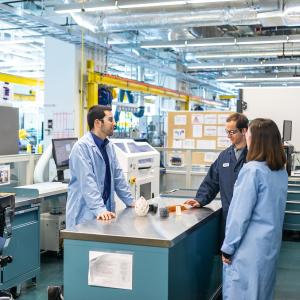 Three people working on a design problem.