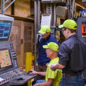 Two people working at a terminal in a warehouse.