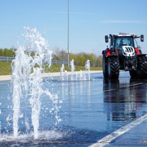 Tractor in front of a water fountain
