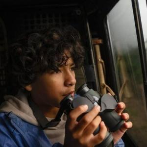 young person holding binoculars