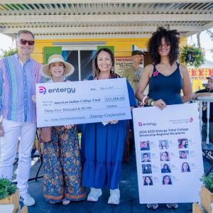 4 people with a large check