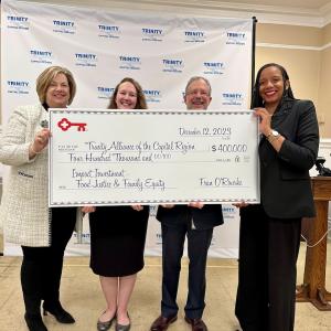 Trinity Alliance representatives receive a $200,000 grant from KeyBank.