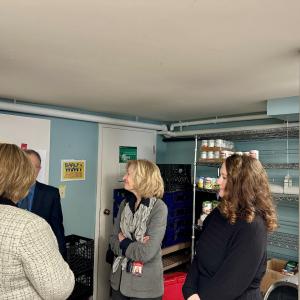 Trinity Alliance team showing KeyBank team the food pantry.