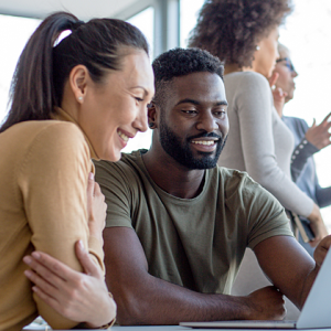 two people looking at laptop screen