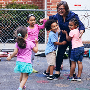 woman hugging 4 small children