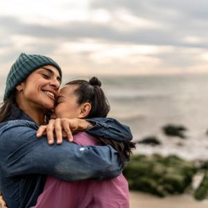 Two people hugging on the beach