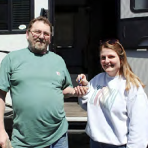 Two people stood next to each other smiling