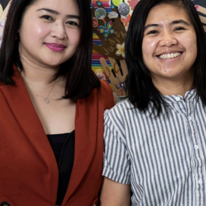 Two people stood together smiling