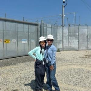 Two people stood together wearing safety hats 