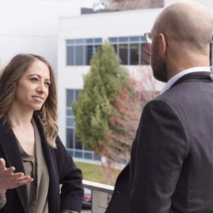 Two people stood talking to each other outside