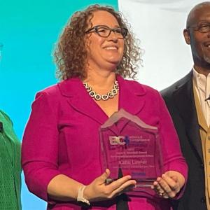 Katie Lawler, center, was recently recognized by Ethics & Compliance Initiative with its Carol R. Marshall Award for Innovation in Corporate Ethics.