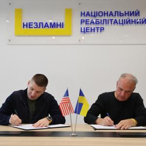 2 people signing documents