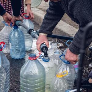 People filling up bottles of water