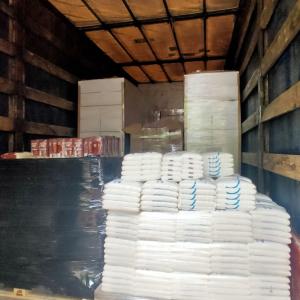 inside a trailer, pallets of wrapped supplies, food, etc.