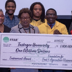 People holding a cheque for Tuskegee University 
