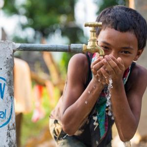 Child drinking water from a spout