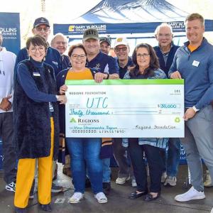 Group of people holding a cheque  