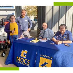 Four people stood at an event stand