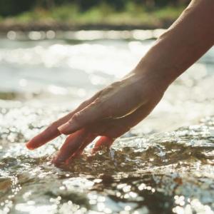 Hand touching water