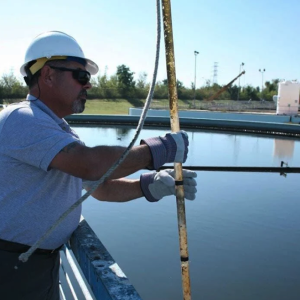 worker over water container