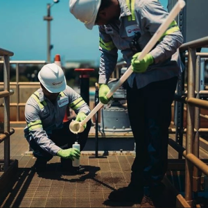 two workers testing water