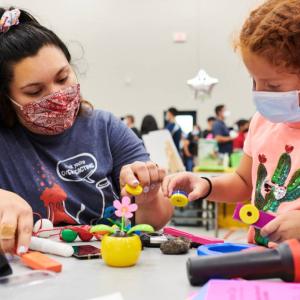Eighth grade science teacher GabrielaTorres and student Sophia C. experiment with magnets at the rollout event. Credit: Saeed Rahbaran