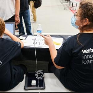 Tech team members Ashden Parker and Devyn Beat help with device distribution. Credit: Saeed Rahbaran