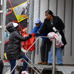 Volunteers handing off presents