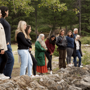 Veronica and others standing at a river bank looking out.