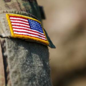 Close up of an American flag on a military uniform.