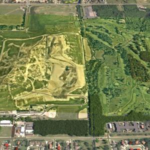 aerial view of a town with large green space in the middle