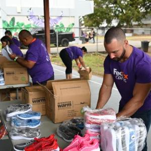 FedEx team members packing shoes to be delivered to local schools.